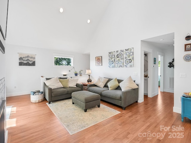 18 Covington St, Asheville, NC 28806 - living area with plenty of natural light, high vaulted ceiling, and light wood-style flooring