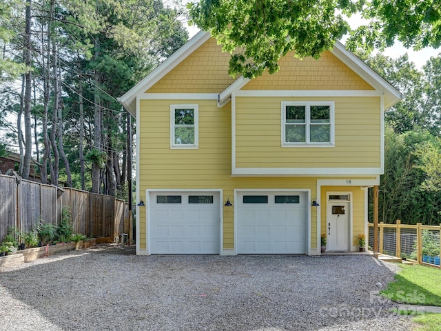18 Covington St, Asheville, NC 28806 - view of front of property featuring an attached garage, gravel driveway, and fence