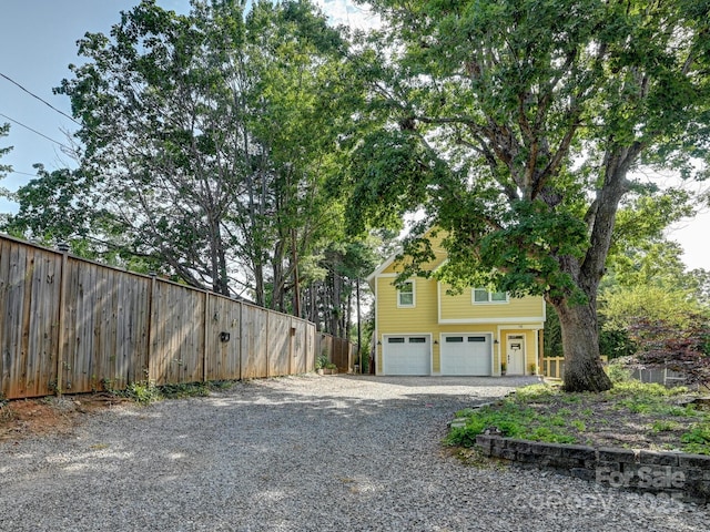 18 Covington St, Asheville, NC 28806 - view of side of property with a garage, driveway, and fence