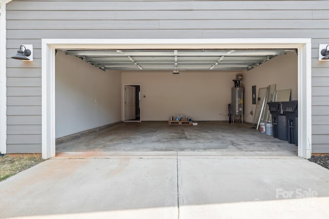 13210 Kenworth Rd, Charlotte, NC 28278 - garage featuring water heater, electric panel, and driveway