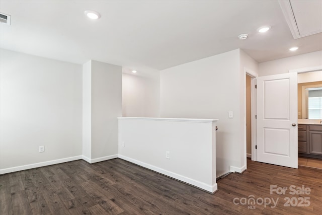 13210 Kenworth Rd, Charlotte, NC 28278 - spare room with a smoke detector, dark wood-style flooring, attic access, and recessed lighting