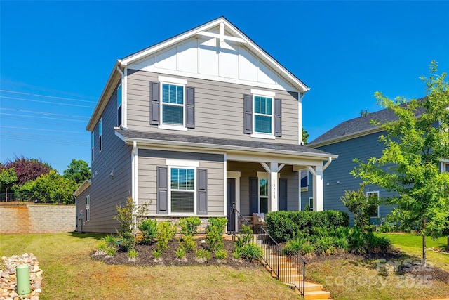 13210 Kenworth Rd, Charlotte, NC 28278 - view of front of property with covered porch, board and batten siding, and a front yard