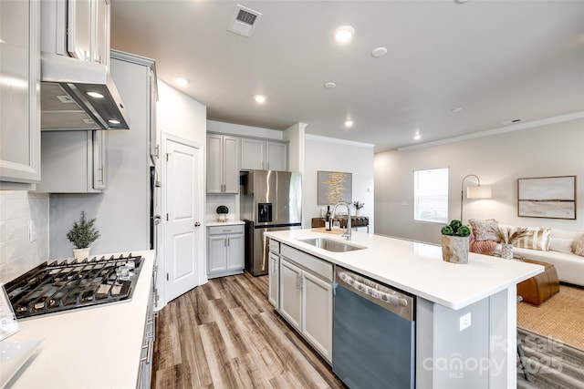 13210 Kenworth Rd, Charlotte, NC 28278 - kitchen featuring stainless steel appliances, under cabinet range hood, open floor plan, gray cabinetry, and light wood-style flooring