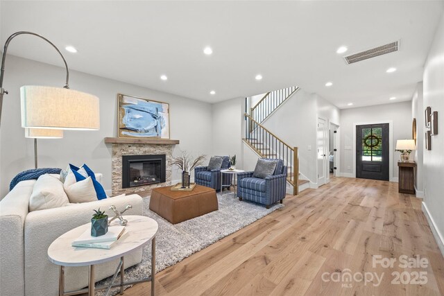 1 Linestowe Dr, Belmont, NC 28012 - living room featuring light wood-style flooring, visible vents, recessed lighting, stairs, and a stone fireplace