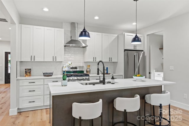 1 Linestowe Dr, Belmont, NC 28012 - kitchen with wall chimney range hood, tasteful backsplash, a sink, a breakfast bar, and stainless steel appliances