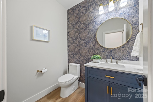 1 Linestowe Dr, Belmont, NC 28012 - bathroom with toilet, baseboards, wallpapered walls, wood finished floors, and vanity