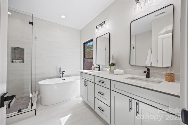 1 Linestowe Dr, Belmont, NC 28012 - full bathroom with a shower stall, double vanity, visible vents, a sink, and a freestanding tub