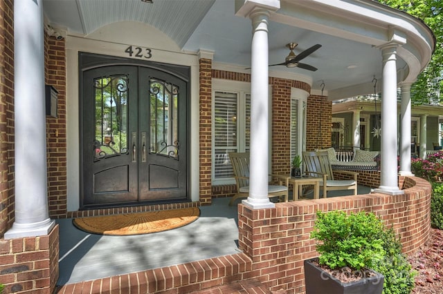423 N Pine St, Charlotte, NC 28202 - property entrance with a porch, brick siding, a ceiling fan, and french doors