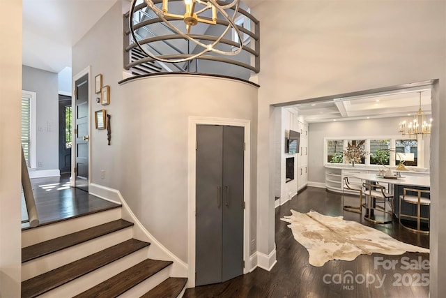 423 N Pine St, Charlotte, NC 28202 - foyer entrance with stairs, wood finished floors, baseboards, a high ceiling, and a notable chandelier