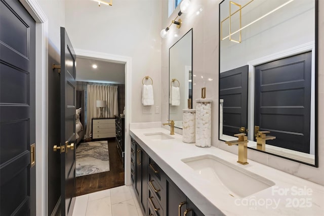 423 N Pine St, Charlotte, NC 28202 - full bath with double vanity, a sink, marble finish floor, and a towering ceiling