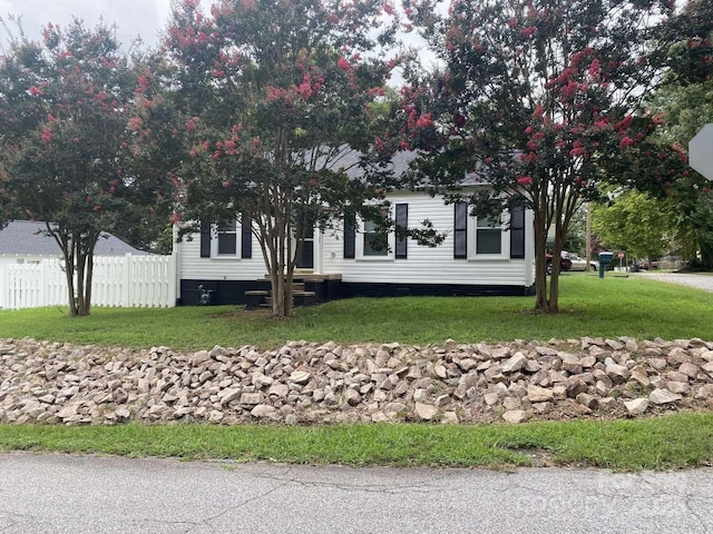 manufactured / mobile home featuring crawl space, a front yard, and fence