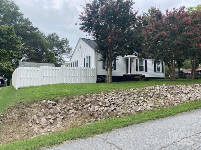 view of side of property featuring fence