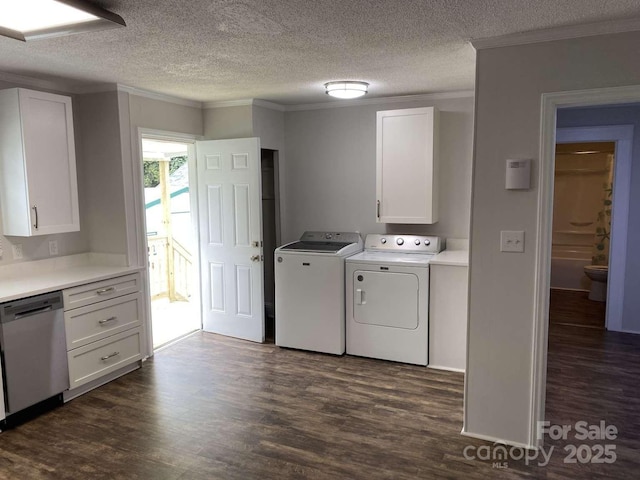 laundry area featuring washing machine and clothes dryer, ornamental molding, a textured ceiling, and dark wood-type flooring