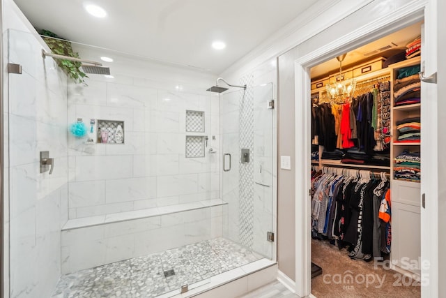 full bathroom featuring recessed lighting, a notable chandelier, a stall shower, and a walk in closet