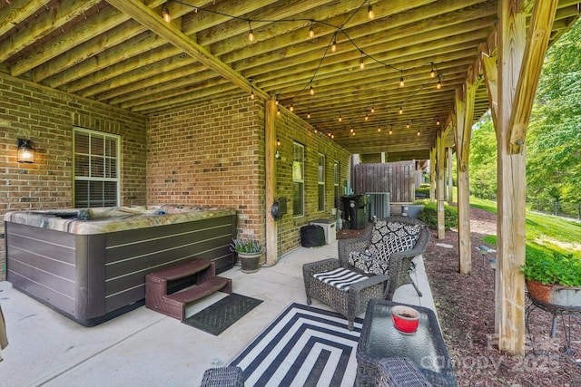 view of patio / terrace featuring central AC and a hot tub