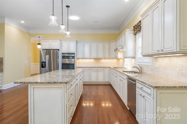 kitchen featuring a sink, appliances with stainless steel finishes, light stone countertops, dark wood-style floors, and a kitchen island