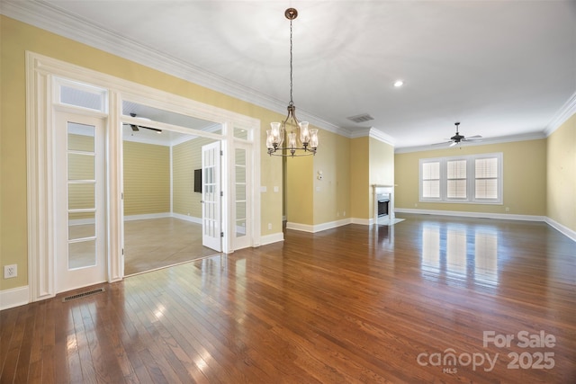 unfurnished dining area with baseboards, dark wood-style flooring, visible vents, and ceiling fan with notable chandelier