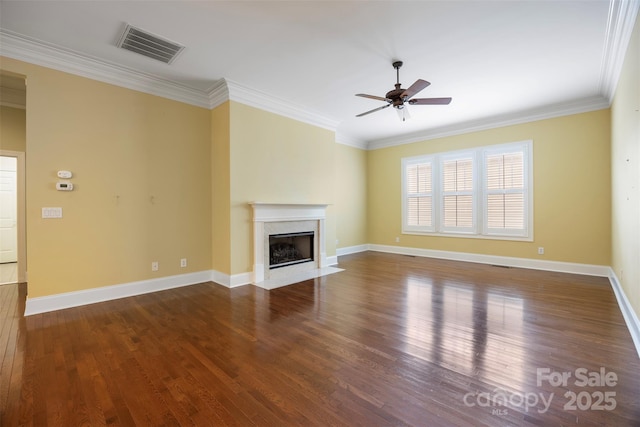 unfurnished living room featuring visible vents, a high end fireplace, wood finished floors, ceiling fan, and ornamental molding