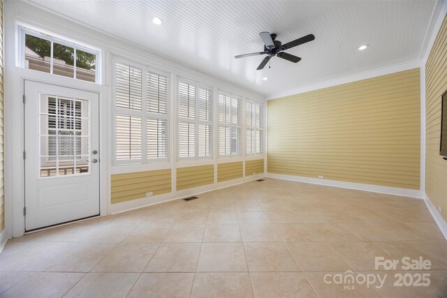 unfurnished sunroom with a ceiling fan and visible vents