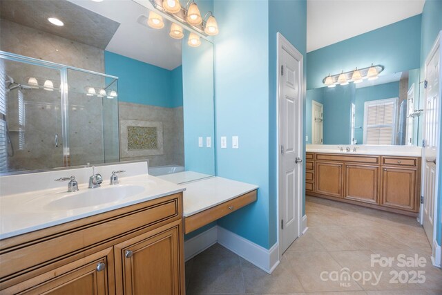 full bath featuring tile patterned flooring, a sink, baseboards, two vanities, and a stall shower