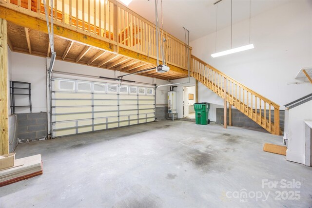 garage featuring gas water heater and a garage door opener