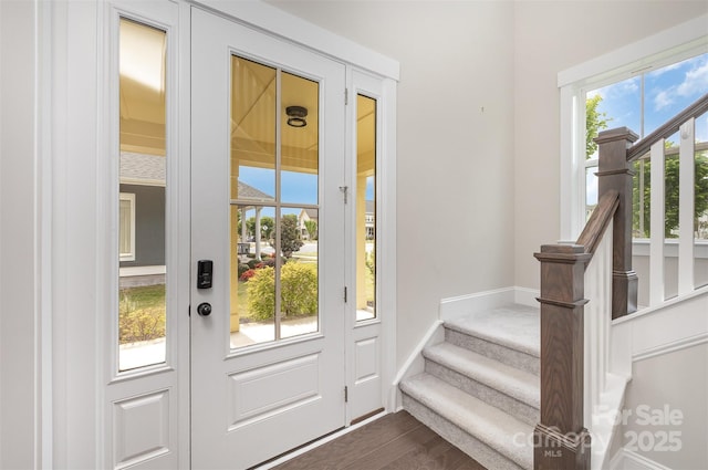 entryway with baseboards, stairway, and dark wood finished floors