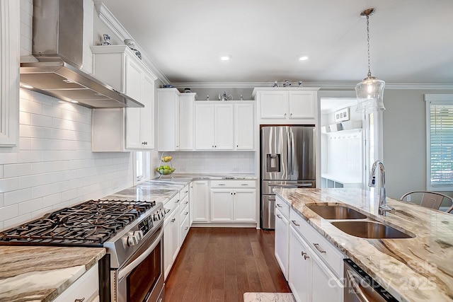 kitchen with stainless steel appliances, a sink, wall chimney exhaust hood, crown molding, and dark wood-style flooring
