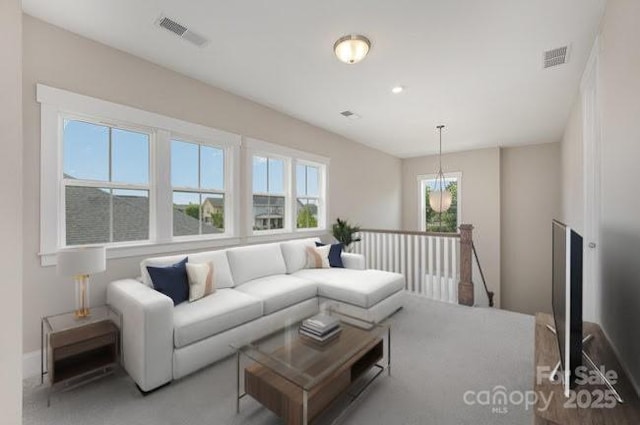 living area featuring baseboards, visible vents, and recessed lighting