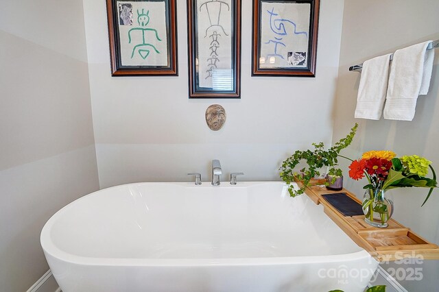 full bath featuring a soaking tub