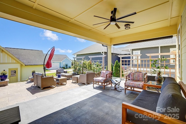 view of patio featuring an outdoor structure, an outdoor hangout area, and a ceiling fan