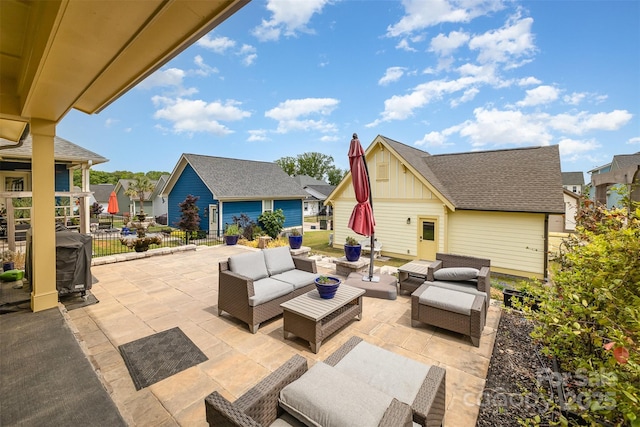 view of patio with grilling area, outdoor lounge area, a residential view, and fence