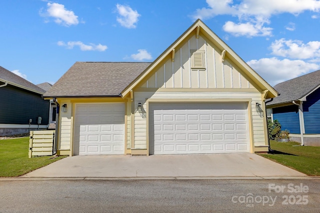 view of front of property featuring board and batten siding, driveway, a front yard, and roof with shingles