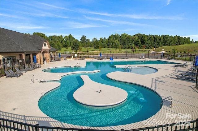 pool featuring a patio area and fence