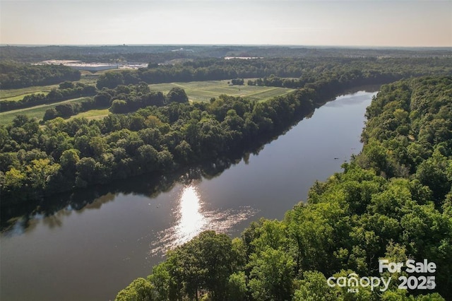 aerial view with a forest view and a water view