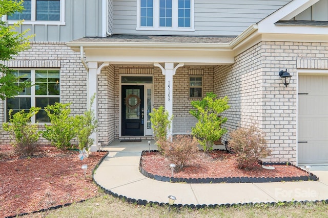 15108 Autumn Sage Dr, Charlotte, NC 28278 - property entrance featuring board and batten siding, brick siding, and a porch