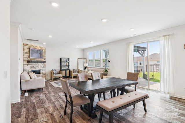 15108 Autumn Sage Dr, Charlotte, NC 28278 - dining space featuring wood finished floors, a fireplace, crown molding, recessed lighting, and baseboards