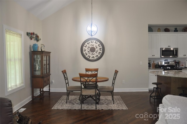 5817 Wingate Hill Rd, Denver, NC 28037 - dining space featuring dark wood-style floors, vaulted ceiling, and baseboards