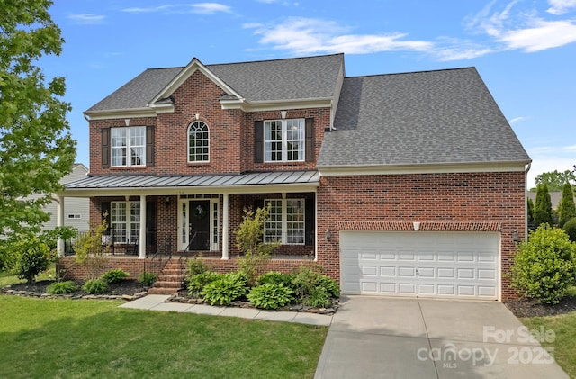traditional-style house with covered porch, concrete driveway, brick siding, a garage, and a front yard