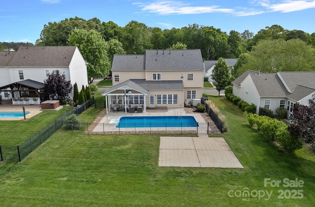 exterior space with a fenced backyard, a patio area, a lawn, and a fenced in pool