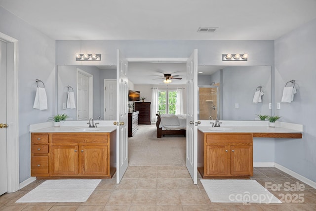bathroom featuring a shower stall, tile patterned floors, ensuite bathroom, and a sink