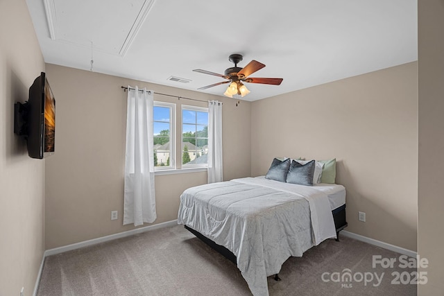 carpeted bedroom featuring attic access, visible vents, a ceiling fan, and baseboards