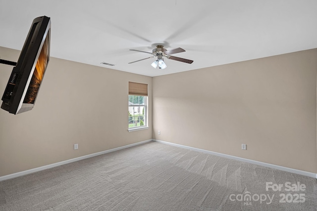 unfurnished room featuring visible vents, carpet flooring, baseboards, and ceiling fan