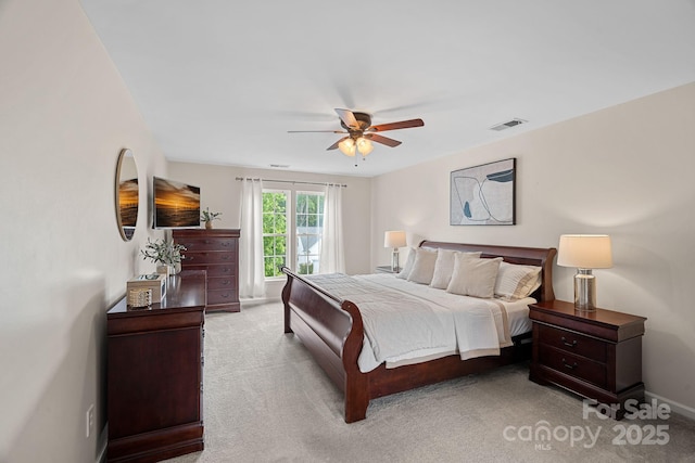 carpeted bedroom featuring baseboards, visible vents, and ceiling fan