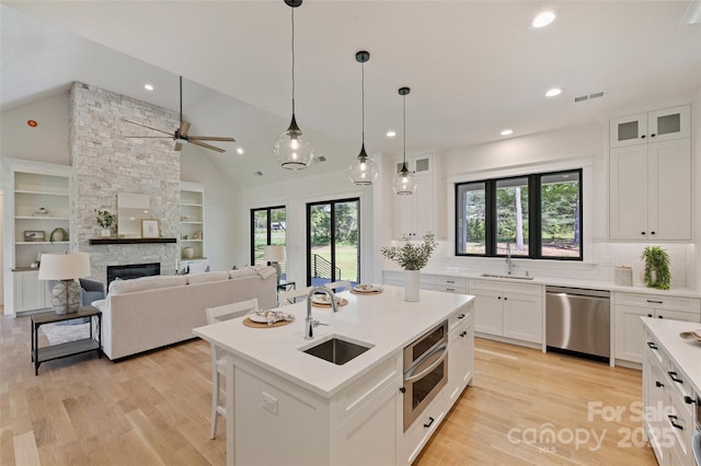 kitchen featuring appliances with stainless steel finishes, a healthy amount of sunlight, and a sink