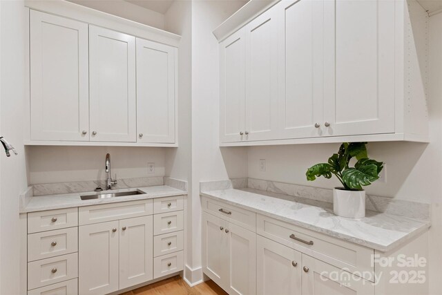 interior space with light wood finished floors and a sink
