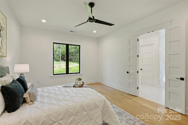 bedroom with light wood finished floors, recessed lighting, ceiling fan, visible vents, and baseboards