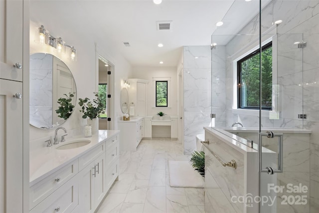 full bath with a sink, a shower stall, a wealth of natural light, and visible vents