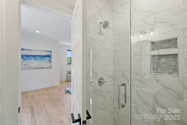 bathroom with recessed lighting, a shower stall, wood finished floors, and baseboards