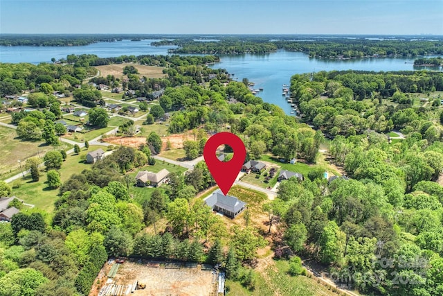 drone / aerial view featuring a water view and a view of trees
