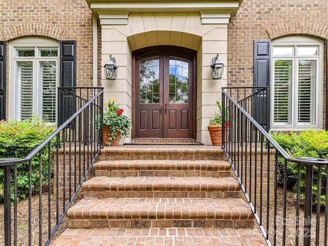 entrance to property featuring brick siding